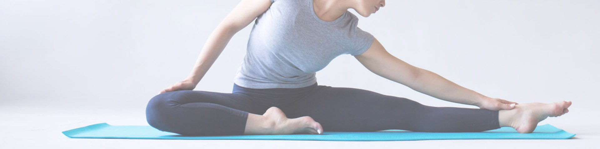 Woman stretching on yoga mat