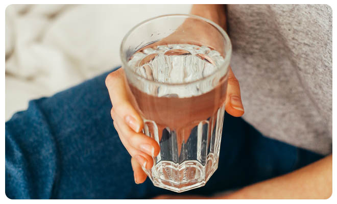 Woman Holding Glass of Water